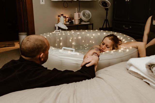 Supportive partner holding hand during birth