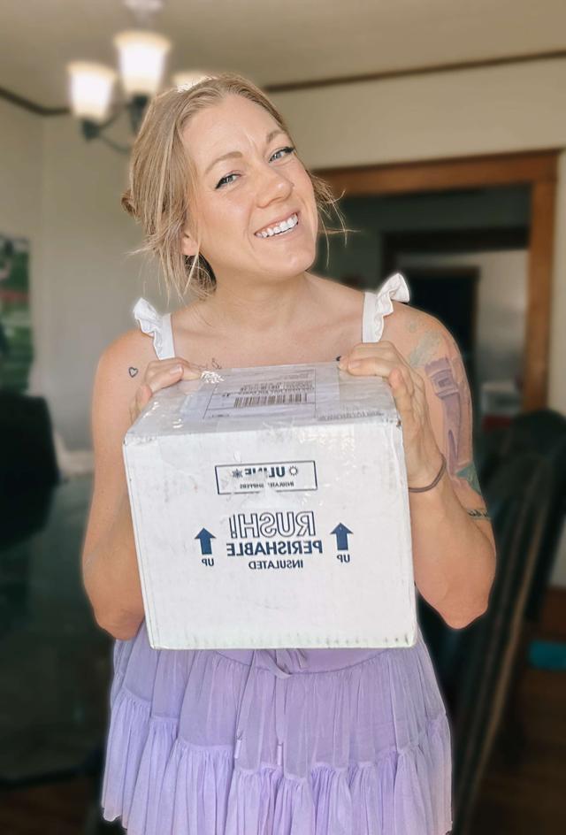Emily holding her product